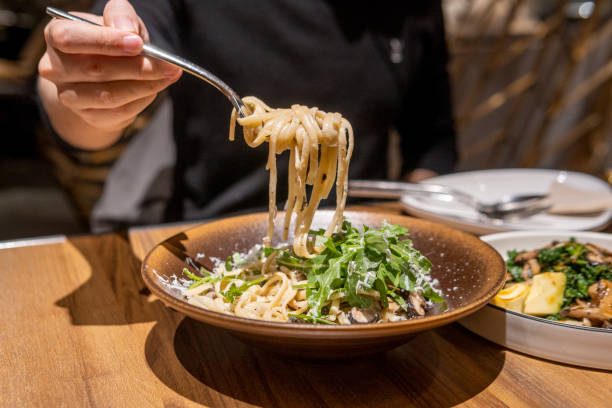 istock People eating vegetable Cream pasta in a vegetarian restaurant 1320794699