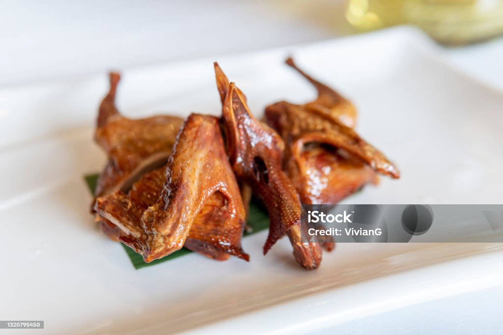 Close-up of Cantonese Siu mei: Roast Squab "烤乳鸽" or Roast Pigeon Meat in Guangdong. Barbecue - Meal Stock Photo
