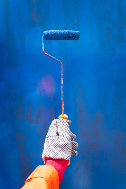 istock A hand of worker is using paint brush for painting job. 1320795546