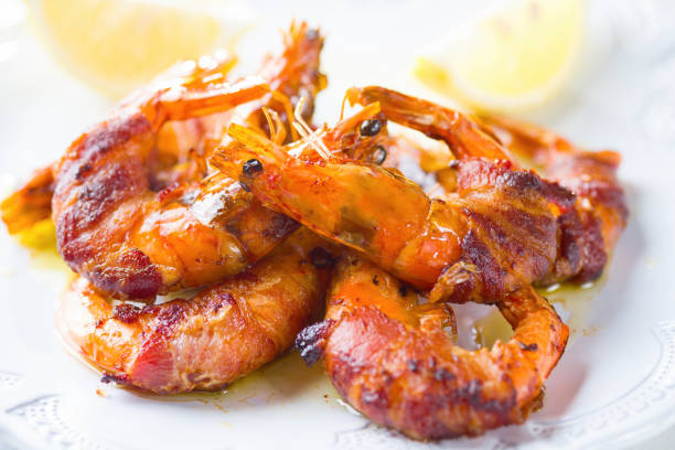 close up of grilled bacon wrapped prawn shrimp seafood