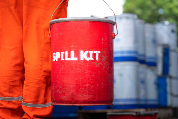 A rescue team is holding red box of "Spill kit" - Industrial emergency scene. A rescue team is holding red box of "Spill kit", ready to response on chemical spilling accident. Industrial emergency scene photo. Close-up and selective focus. emergency response workplace stock pictures, royalty-free photos & images