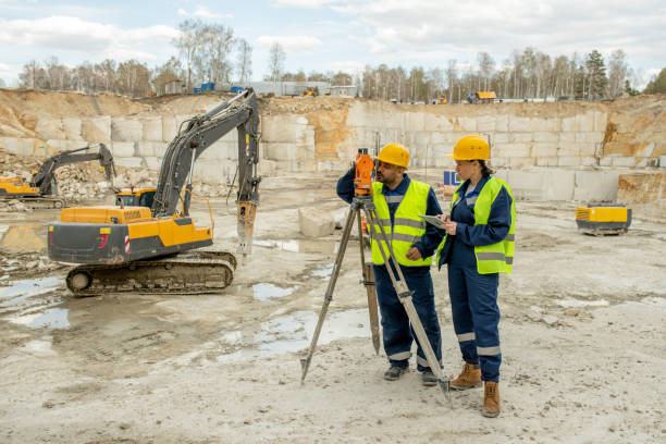 istock Male and female surveyors working on construction site 1320797925