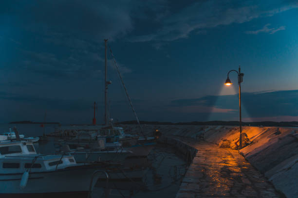 istock city light at quay. twilight over sea bay 1320799018