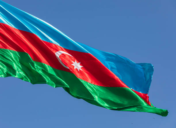 istock Azerbaijan flag waving against the blue sky 1320799339