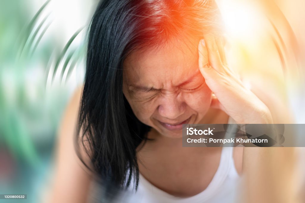 Vertigo illness concept. Woman hands on his head felling headache dizzy sense of spinning dizziness,a problem with the inner ear, brain, or sensory nerve pathway. Headache Stock Photo