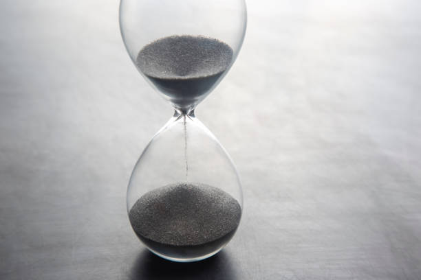 istock Hourglass on a light background. Time is money. Business solutions in time. 1320801415