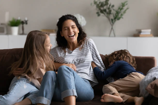 istock Smiling Hispanic mom play with biracial kids 1320801496