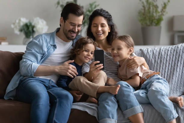 istock Happy family with kids use modern smartphone 1320801497
