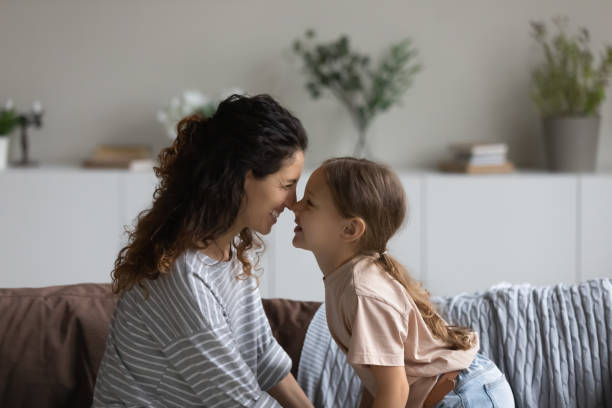 istock Smiling Latin mom cuddle with little daughter at home 1320801502
