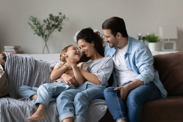 istock Happy parents with small daughter relax at home 1320801505