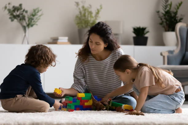 istock Loving Hispanic mom play with biracial children 1320801550