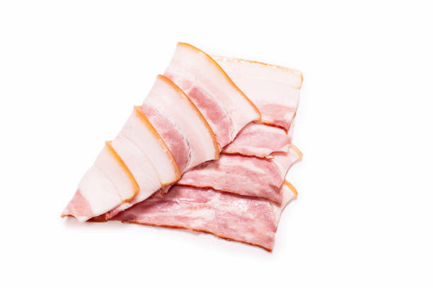 istock Raw bacon slices isolated on a white background. 1320801882