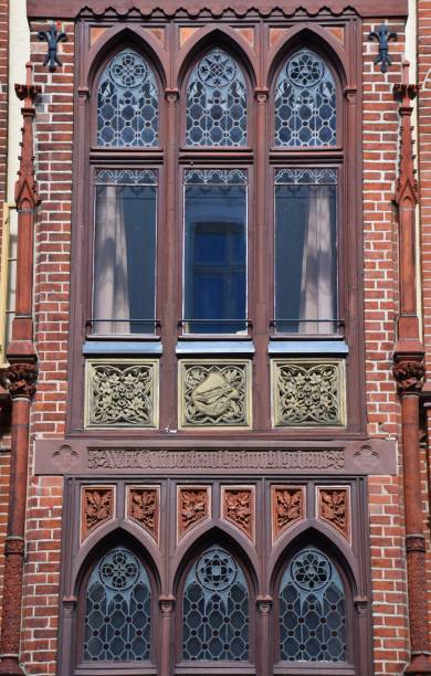 istock Ancient, red bricked facade with artful decorated window in Schwerin, Germany 1320802752
