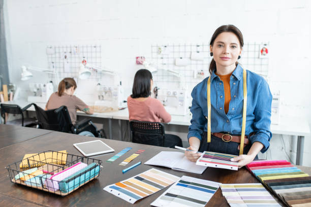 istock Pretty female fashion designer at work 1320802948