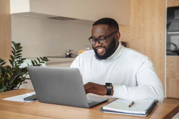istock Smiling young afro american man freelancer studying or working online on laptop 1320804012