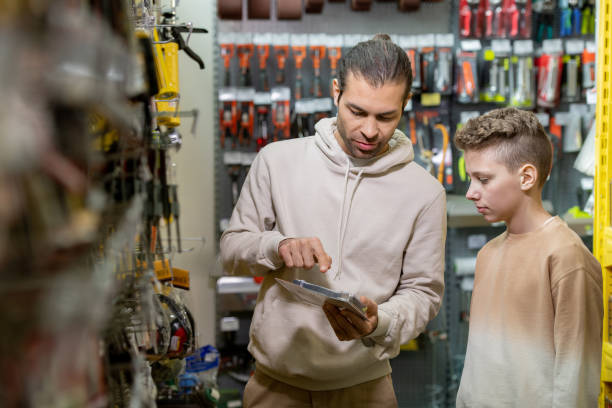 istock Young man pointing at household good while showing it to his son 1320806749