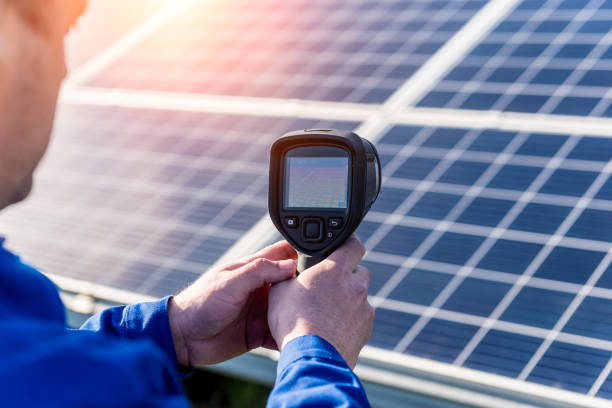 istock Inspector examination of photovoltaic modules using a thermal imaging camera 1320806949