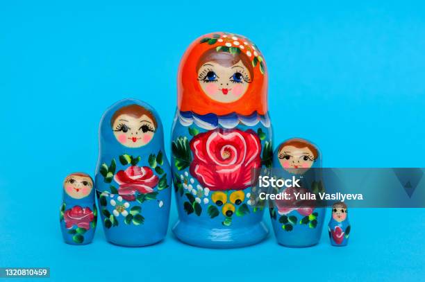 Russian Wooden Doll Matryoshka On Blue Background Stock Photo - Download Image Now - Russian Nesting Doll, Blue, Souvenir
