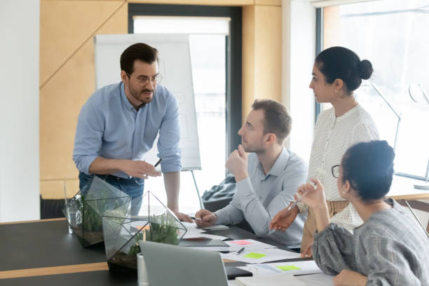 istock Diverse colleagues employees team with leader brainstorming, gathering in boardroom 1320811352