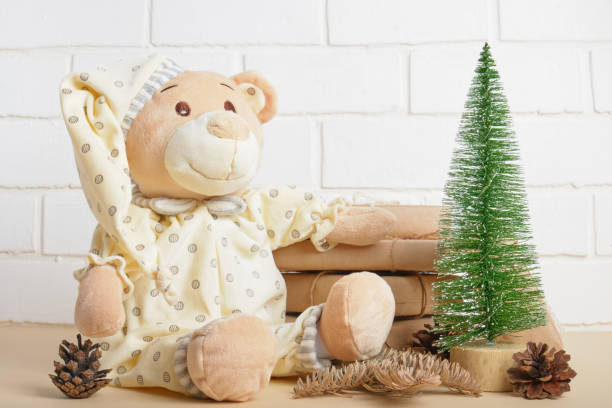 istock cute teddy bear and christmas gift boxes on brick white wall background 1320814371