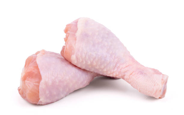 istock Two raw chicken drumsticks isolated on white background 1320815625