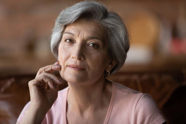 istock Head shot portrait attractive grey haired older woman 1320817093