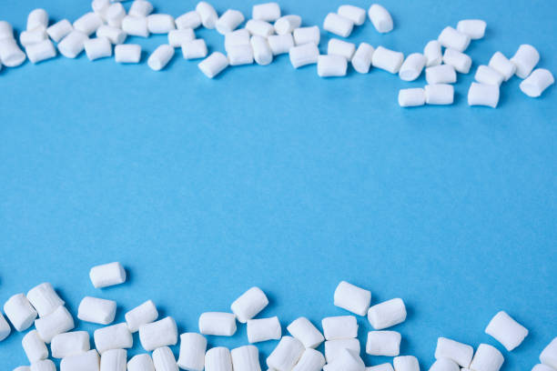 istock small white marshmallows are scattered on a blue background copy space, focus at the bottom of the image, marmalade frame 1320818864