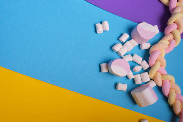istock different types of marshmallows with different flavors on a bright colored background, long spaghetti-shaped marshmallows are braided in a pigtail 1320818896