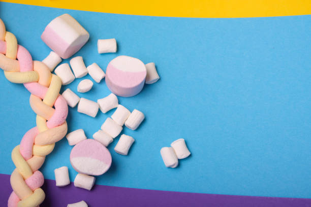 istock different types of marshmallows with different flavors on a bright colored background, long spaghetti-shaped marshmallows are braided in a pigtail 1320818900