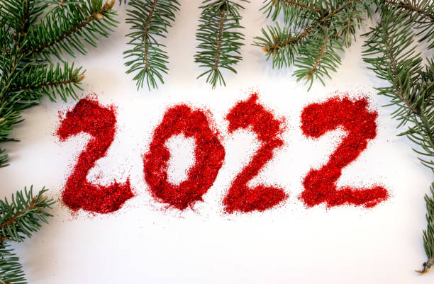 istock Inscription 2022 with spruce branches, pinecones on a white background. 1320821168