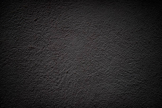 istock Black grunge background with vignette. Plaster texture. 1320821254