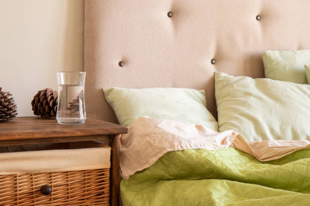 istock Cozy bedroom interior. Bed, pillows and wooden bedside table. 1320821260