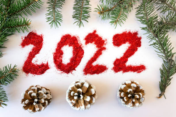istock Inscription 2022 with spruce branches on a white background. 1320821292
