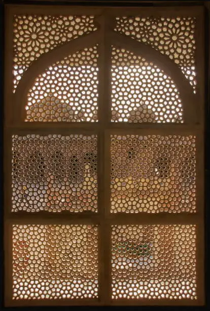 Palace shape behind a carved window in Fatehpur Sikri, Agra, India