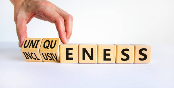 istock Inclusiveness and uniqueness symbol. Businessman turns wooden cubes, changes words inclusiveness to uniqueness. Beautiful white background. Business, inclusiveness and uniqueness concept. Copy space. 1320823667