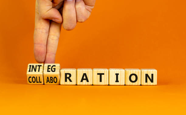 istock Integration or collaboration symbol. Businessman turns cubes, changes words 'collaboration' to 'integration'. Beautiful orange background. Business, integration or collaboration concept. Copy space. 1320823686