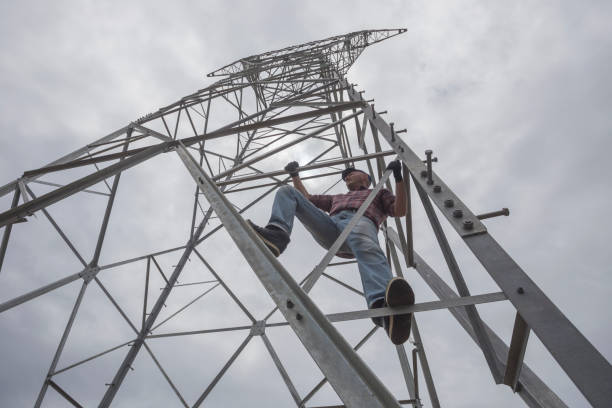 istock Building new electricity pylon. Worker is climbing up on pylon 1320824682