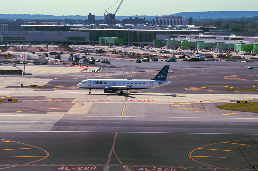 5/27/2021 - Newark, New Jersey, USA:   Aerial shot of a Jet Blue 737 on the taxi way at Newark-Liberty Airport in Newark, New Jersey.