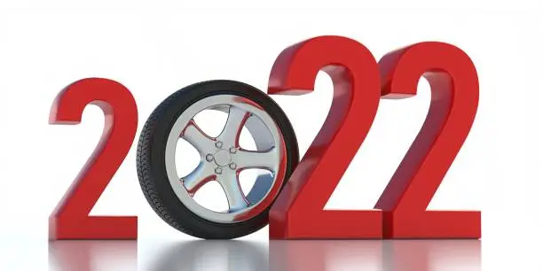 2022 New year safe drive concept. Tire on alloy wheel between red digits isolated on white background.  Greeting card for car spare parts, drivers garage, service. 3d illustration