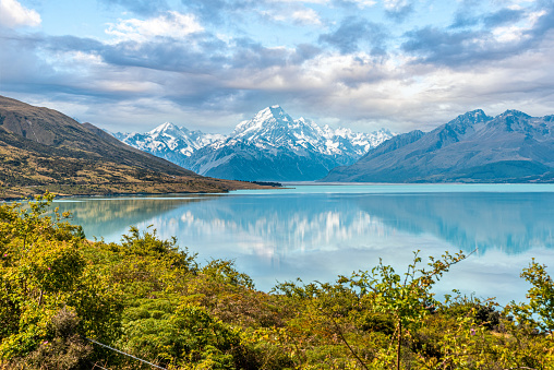 Scenic reflection of Mount Sefton and Mount Cook at lake Pukaki, South Island of New Zealand