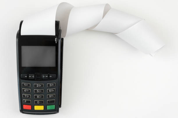 istock Payment terminal POS with a roll cash tape on the white background with copy space 1320836853