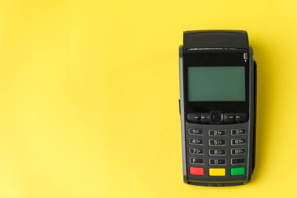 istock Payment terminal POS on the yellow background with copy space 1320837112