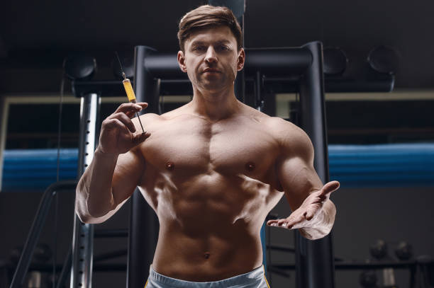 istock athlete holds a syringe, injector 1320837149