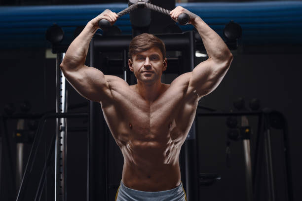 istock athletic man exercising pumping up triceps muscles 1320837309