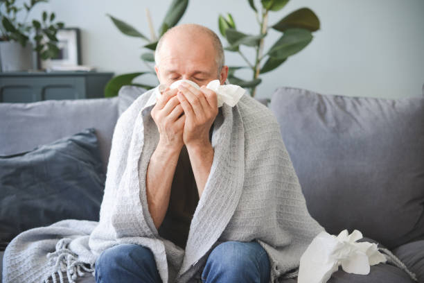 istock sick man sitting on a sofa in the room 1320838105