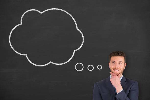 istock Business man standing next to thought bubble drawn on chalkboard 1320841280