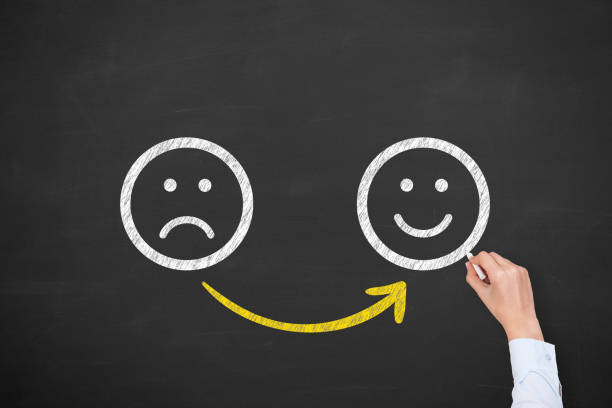 istock Hand Drawing Unhappy and Happy on Blackboard 1320842355