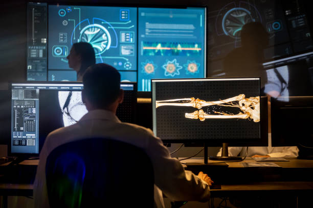 istock Man working in modern office. 3D model of human leg bones. 1320844531