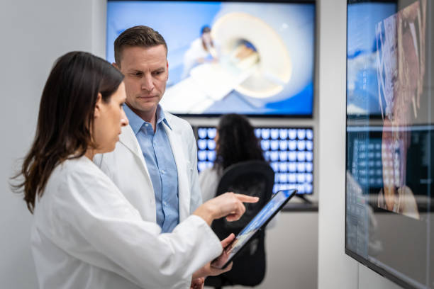 istock Viewing examination results on digital tablet and large touch screen. 1320844561