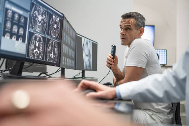 istock Doctor viewing scan results and dictating report. 1320844593